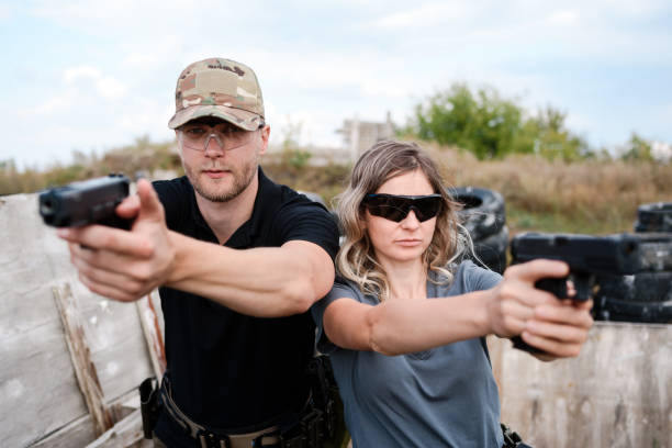 istock A girl learns to shoot a pistol at a shooting range with an instructor 2155398693