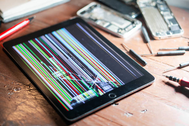 istock Tablet with damaged screen and repair tools 2155399789
