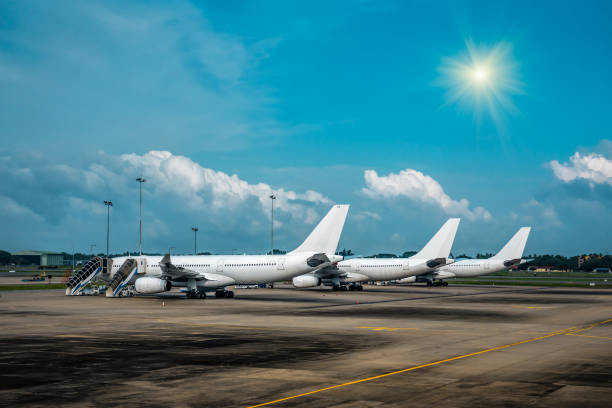 istock Three white passenger airplane in airport 2155403543