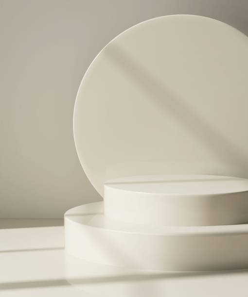 istock Modern and minimal beige geometric round cylinder podium in sunlight, shadow on abstract wall 2155404082