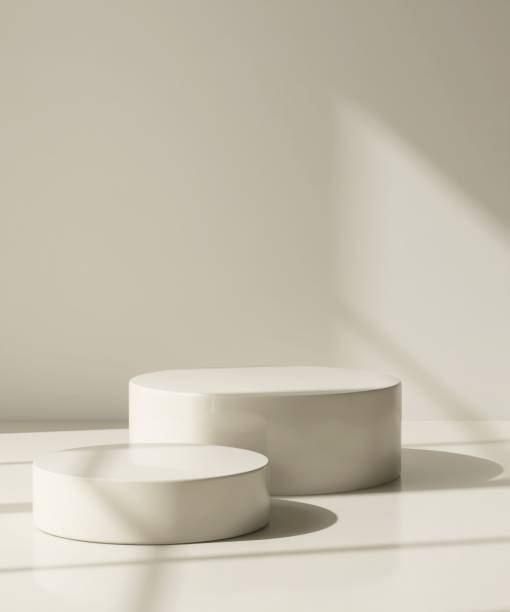 istock Two modern and minimal beige geometric round cylinder podium in sunlight, shadow on wall 2155404099
