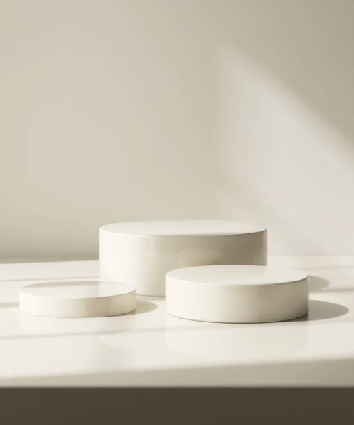 Three modern and minimal beige geometric round cylinder podium in sunlight, shadow on wall