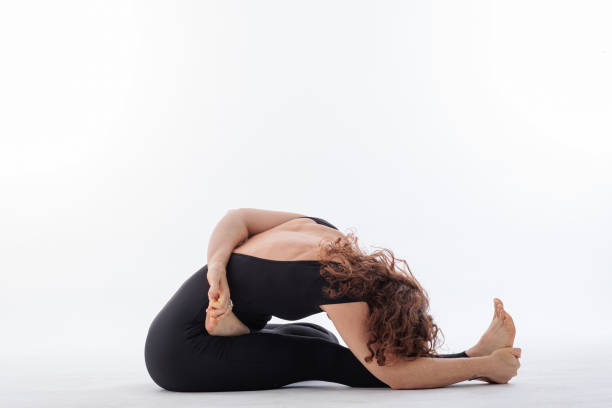 istock Peaceful yoga practice in the studio on white background with a beautiful woman 2155404361