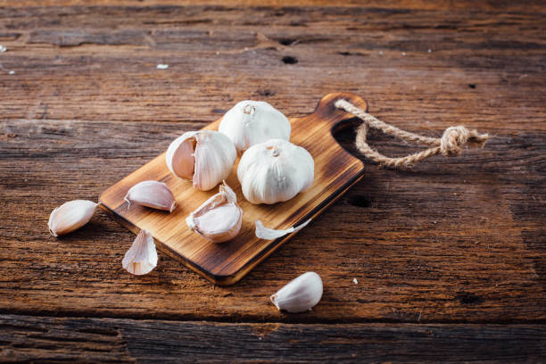 istock garlic on wooden background 2155404473
