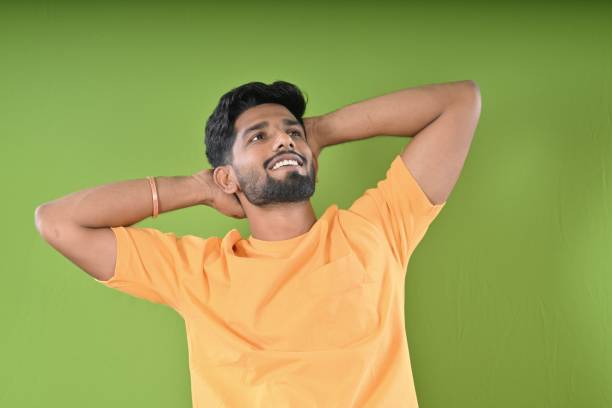 In this portrait, a young man is depicted with a bright, genuine smile against a colorful background. His cheerful expression conveys a sense of happiness and positivity, creating a vibrant and uplifting image. The colorful backdrop adds to the energetic and lively atmosphere of the scene