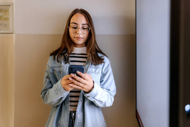 istock Portrait of female student text messaging on her smart phone 2155406480