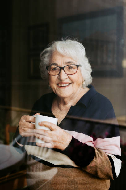 istock Elderly woman drinking coffe at home. 2155408155