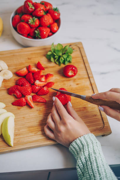 istock Woman slicing strawberries on a cutting board 2155408903