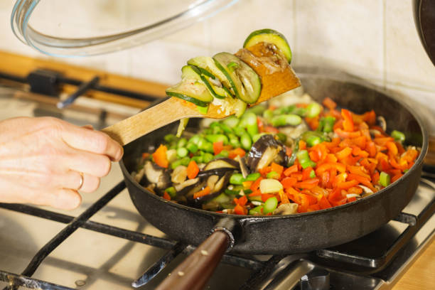 Dieting eating, preparing food concept. Many chopped healthy vegetables on frying pan, food p
