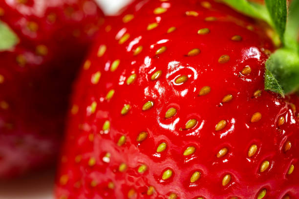 A macro shot of a ripe red strawberry