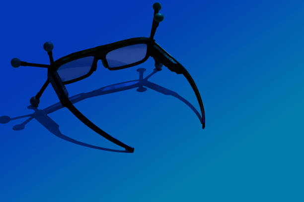 3D glasses on blue background. Glasses for three-dimensional vision of objects. Black glasses with antennas on a blue table. Modern gadgets. New technology.