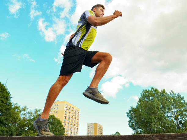 istock Young man running in park 2155417258