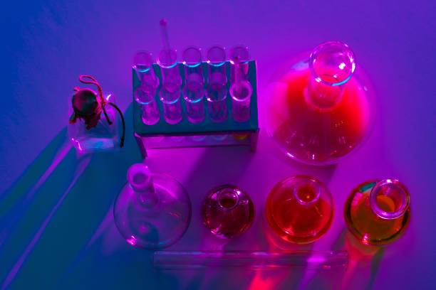 Laboratory analysis. Flask and test tubes on white table indoors, closeup. Laboratory test-tubes and retorts. Scientific equipment at laboratory.