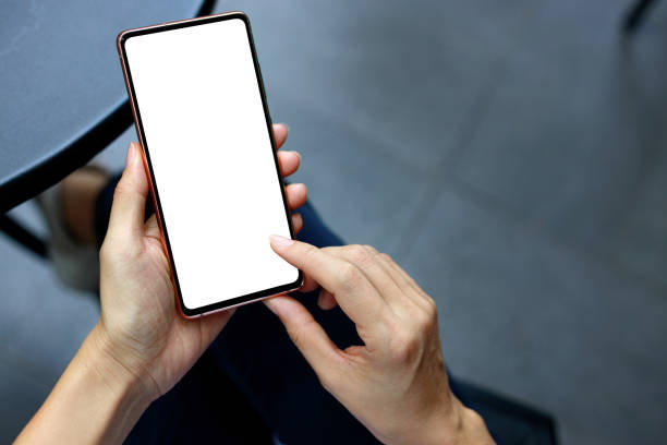 istock Cropped image of a woman's hands holding a smartphone with a blank screen, perfect for design and mockup purposes. 2155420332