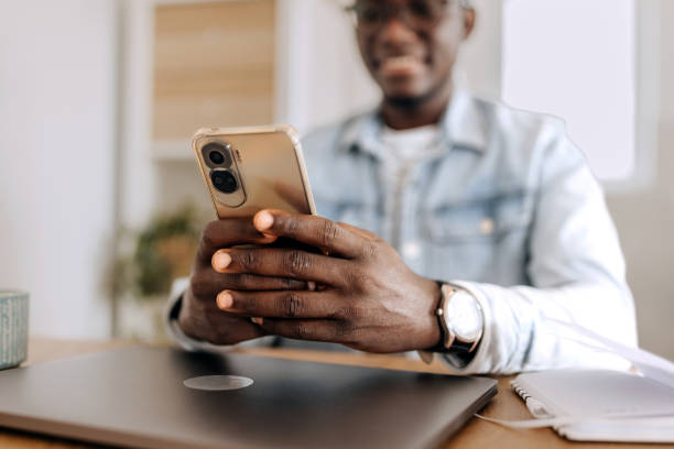 istock Close up shot of young casually clothed man text messaging while working at home office 2155422514