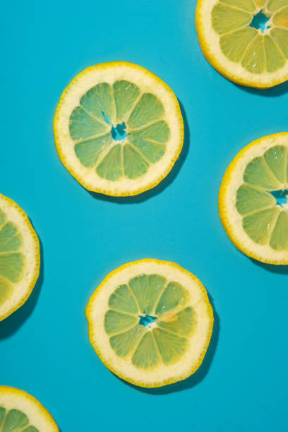 istock Flat lay of lemon slices on blue background 2155423829