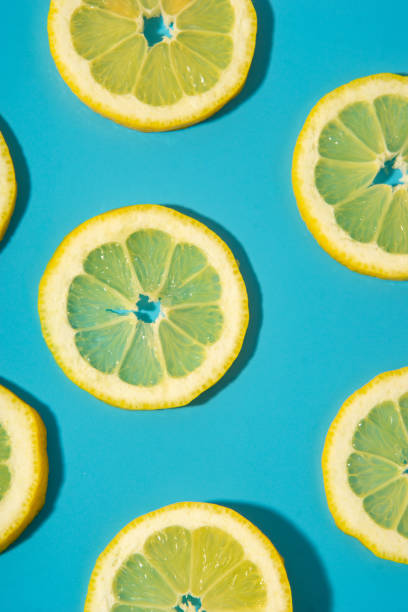 istock Flat lay of lemon slices on blue background 2155423841