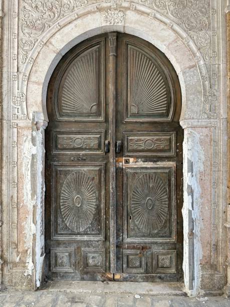 istock Weathered Old Tunisian Double Entry Doors with Decorative Panels 2155427583