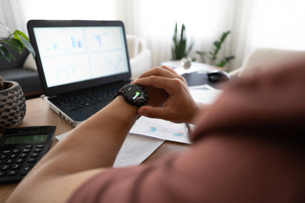 istock Clsoe-up Man working at home with laptop checking stress level from smartwatch 2155427645