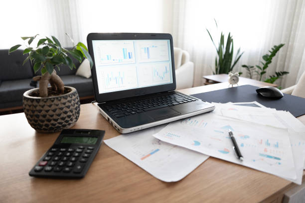 istock Home laptop desk and financial reports 2155427658