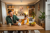 father-and-son-save-money-coins-together-at-piggy-bank-at-home.jpg?b=1&s=170x170&k=20&c=Il_AaVbNbk4KXt_yNgBg7MhEoSnN7J6P4bQqFB8Mvrc=