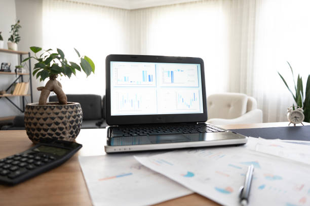 istock Home laptop desk and financial reports 2155427728