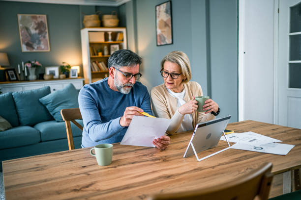 istock Mature couple manages expenses and bills 2155428391