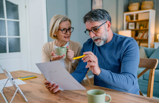 istock Mature couple managing home budget 2155428507