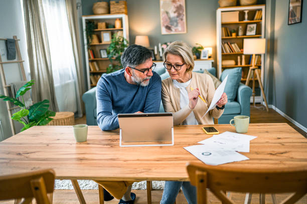 istock Mature couple managing home budget 2155428610