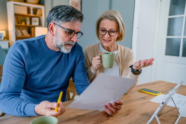 istock Mature couple managing home budget 2155428714