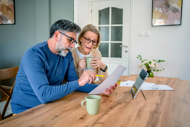 istock Mature couple manages home finances 2155429009