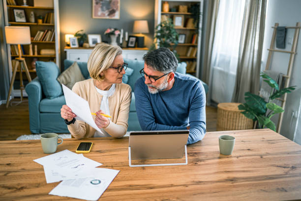 istock Mature couple manages expenses and bills 2155429273