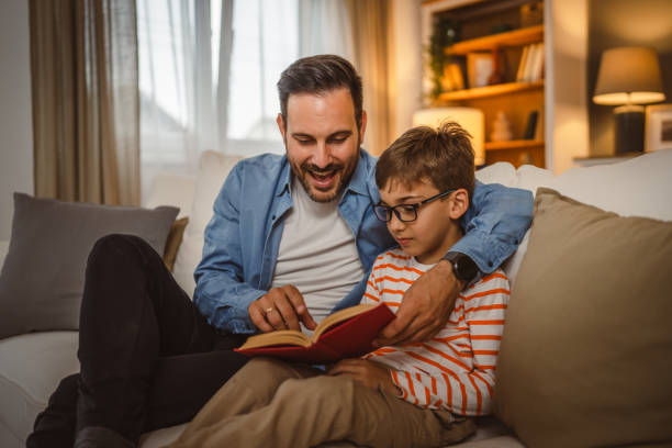 istock Father and son read a book and have fun while spend time together 2155429285
