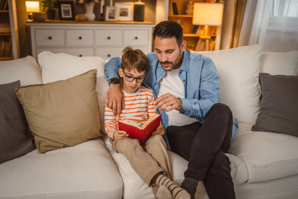 istock Father and son read a book and have fun while spend time together 2155430819
