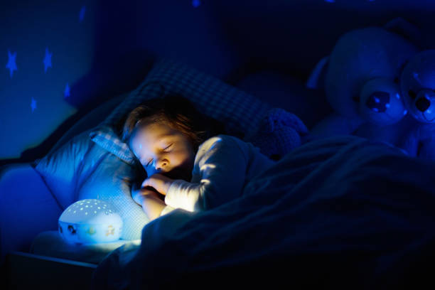 istock Little girl reading a book in bed 2155430965