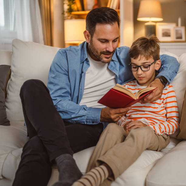 istock Father and son read a book and have fun while spend time together 2155431537