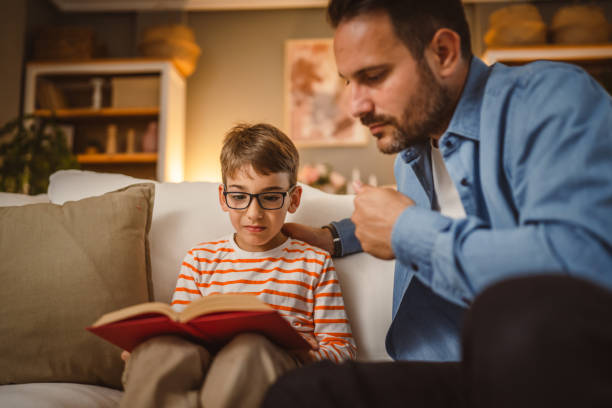 istock Father and son read a book and have fun while spend time together 2155432219