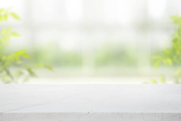 istock Selective focus.Elegance product display background with marble top on blur big window and fresh garden. 2155432246