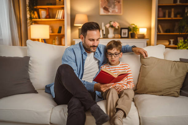 istock Father and son read a book and have fun while spend time together 2155432310