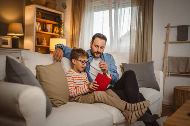 istock Father and son read a book and have fun while spend time together 2155432395