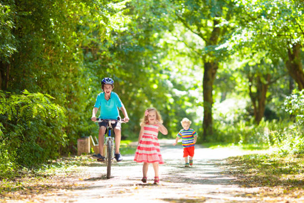 istock Boy riding bike in summer park. Bicycle ride. 2155432405