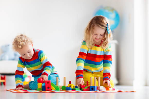 istock Kids playing with wooden toy train 2155433635