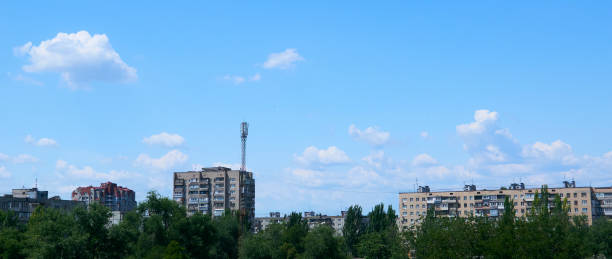 istock white clouds float across the blue sky in the city 2155435194