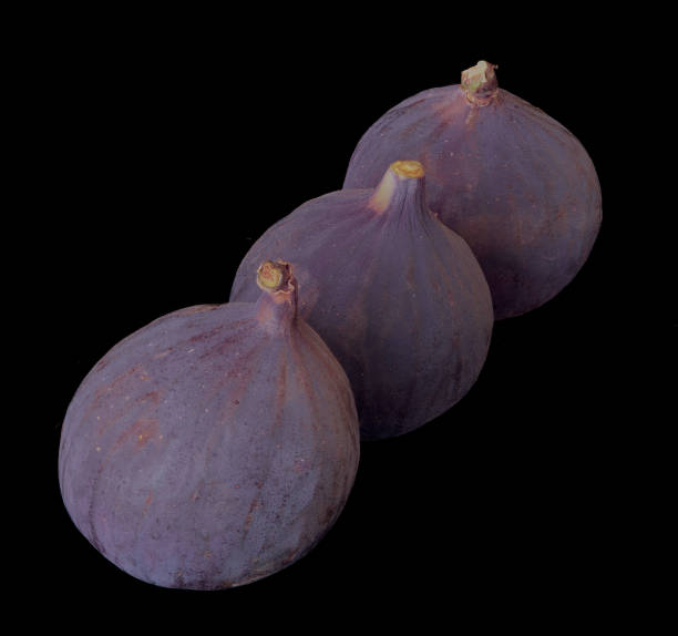 Fig fruits lie on a black background