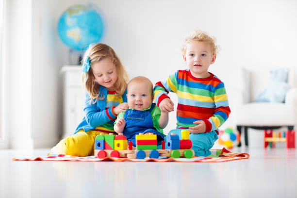 istock Kids playing with wooden toy train 2155435254