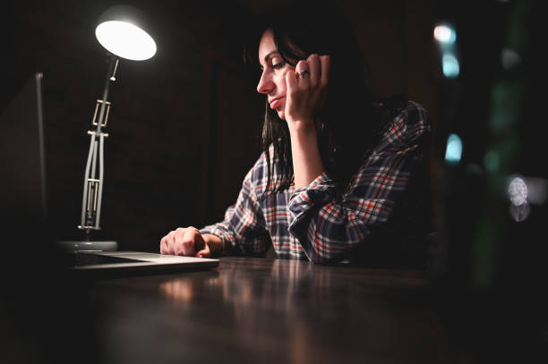 istock Woman working on laptop in late office. 2155437901