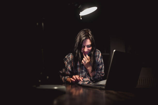 istock Woman online messaging at night. 2155437933