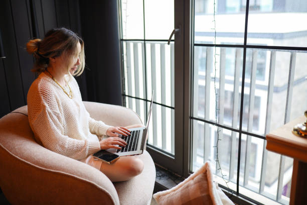 istock Knowledge Worker and Relaxed Young Woman, Working From At Home 2155438030