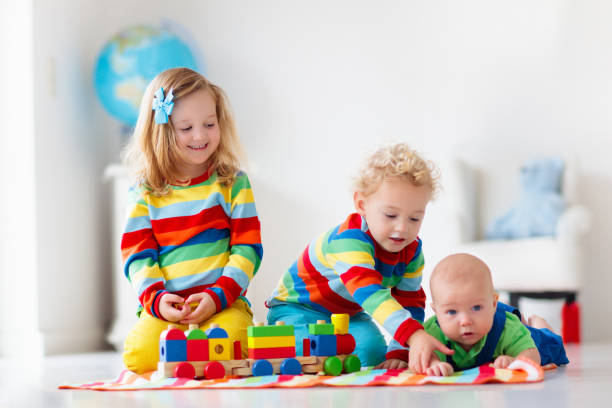 istock Kids playing with wooden toy train 2155440239