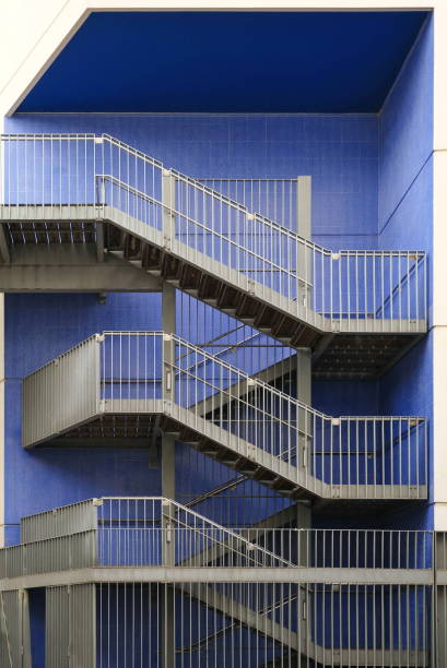 istock Metal gray staircase on a purple background. External staircases. 2155441266
